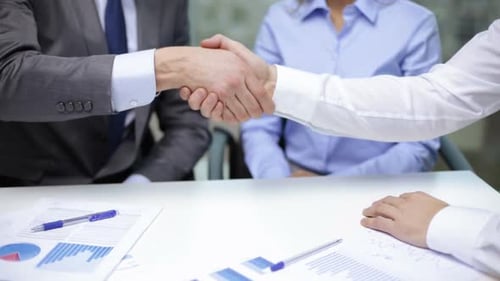 Businessmen shake hands sealing a successful deal in the modern office