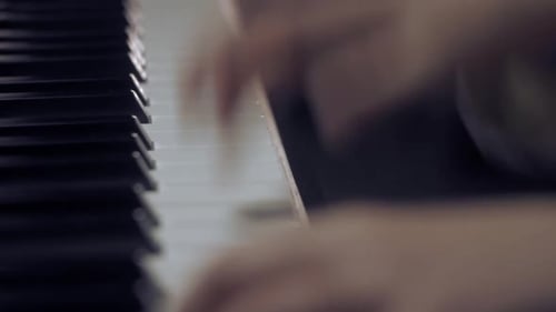 Young boy (10 years old) playing piano, close up of hands