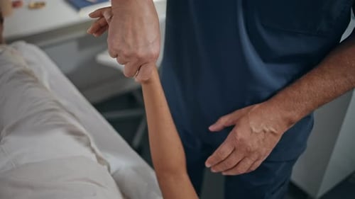 Healthcare Professional Assisting Patient in Physical Therapy