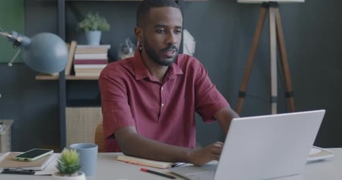 Cheerful Programmer Using Laptop Typing Coding Working with Computer in Office