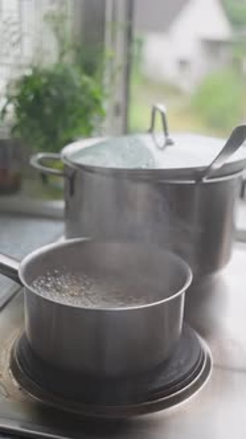 Water Boiling in Stainless Steel Pots on Stove