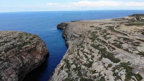 River entering mediterranean sea in Gozo, Malta island valley view from sky