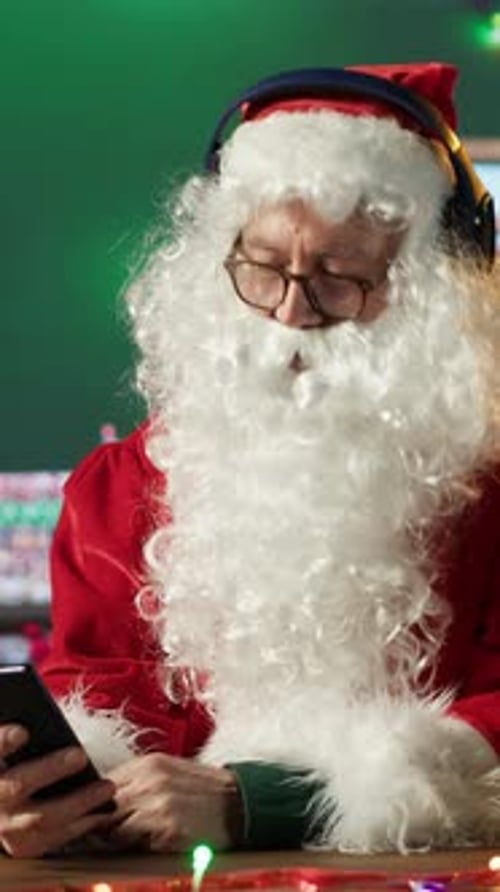 Vertical Video Cheerful Saint Nicholas Listening to Festive Carols Christmas Music on Phone