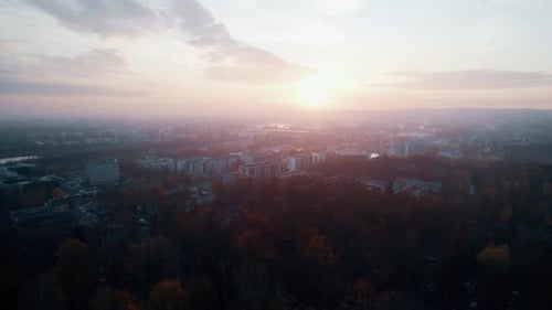 Aerial view of bloody ang foggy sunrise over big city