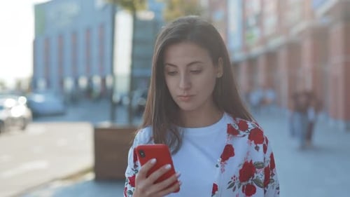 Woman Using Smartphone on City Street