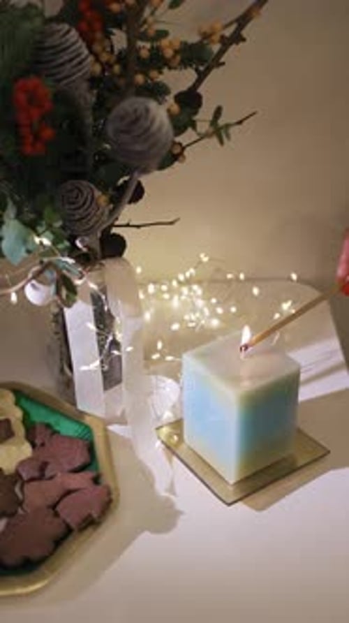 Burning candle close-up. Decorated christmas tree on background. Winter holidays concept. Celebratin