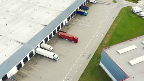 Aerial Perspective of Semi Trucks at Modern Logistics Distribution Center