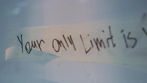 Strip of Masking Tape on Whiteboard with Motivational Quote
