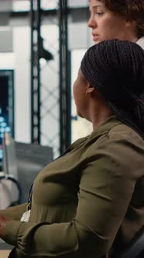 Vertical Video Team of Technicians in Office Working Together Automating Workflows Using AI