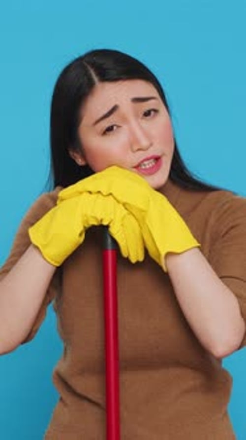 Vertical Video Tired Housekepper Falling Asleep on Broom While Cleaning Client Home Being Overworked