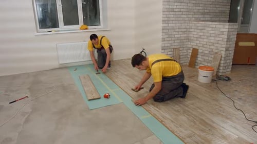 Workers Lay the Floor in the House