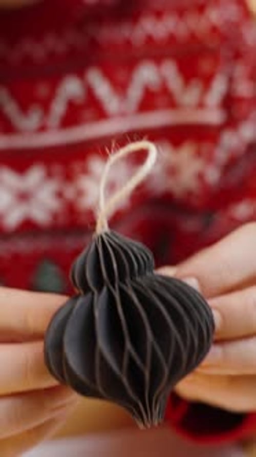 Woman Making Paper Christmas Decorations at Home