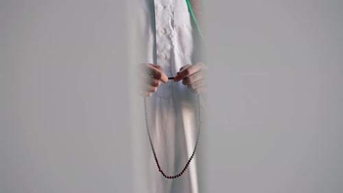 Man with Prayer Beads Praying in a Tunic