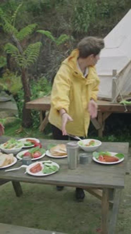 Friends eating outdoors at picnic table