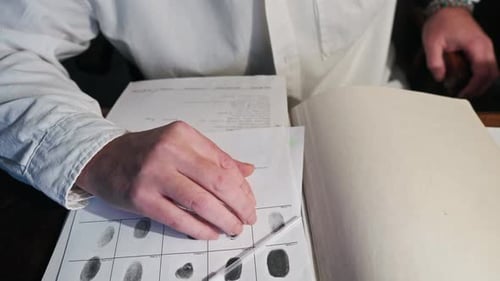 Laboratory forensic analyst study's fingerprint card evidence results