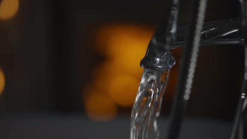 Tap running with fire in background