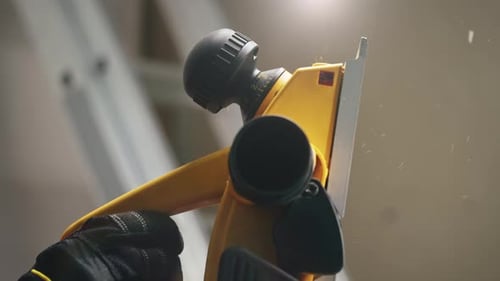 Close-up of Hand Using Yellow Working Tool