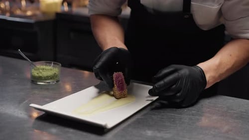 Chef Plating a Tuna Fish Dinner Second Course In Kitchen Of Restaurant