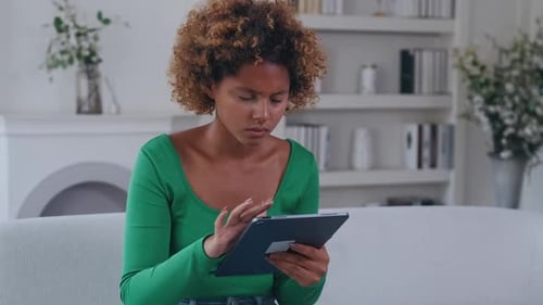 Woman Using Tablet Device Indoors