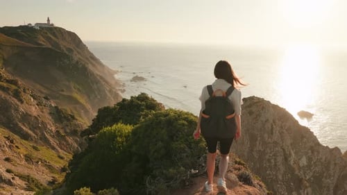 Triumphant Female Hiker Celebrating on Mountain Overlook
