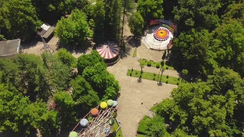 Ferris wheel rotating in empty amusement park