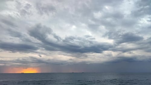 Movement Large Gray Rain Clouds Falling Rain Yelloworange Spot of Rising Sun