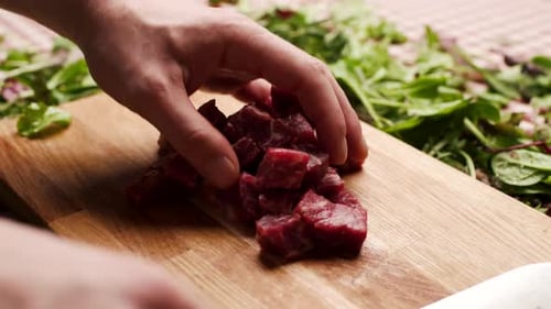 Diced Beef Arranged on Cutting Board with Herbs