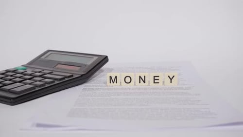 Calculator and "Money" Tiles on White Background