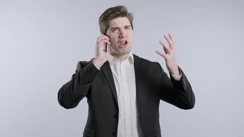 Furious Man Yelling Angrily on His Mobile Phone