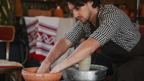 Ceramist uses potter's wheel and creates a handmade clay product