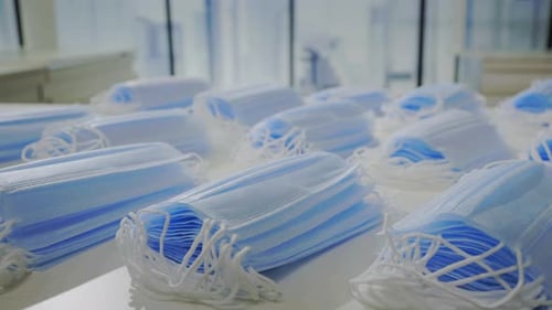 Stacks of Surgical Masks in Bright Workplace