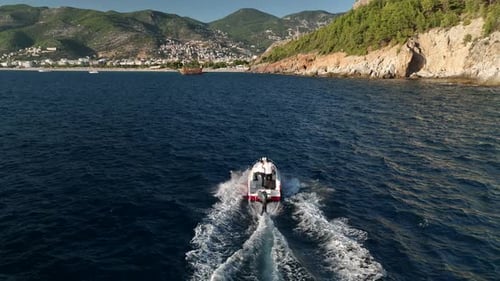 Aerial Drone Tracking Top Down Video of Yacht Cruising in Deep Blue Open Ocean Sea