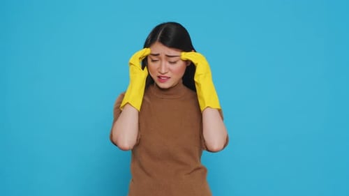 Distressed Woman Wearing Yellow Cleaning Gloves