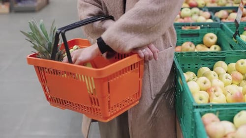 Girl enjoying a leisurely shopping experience in a vibrant supermarket with fresh produce