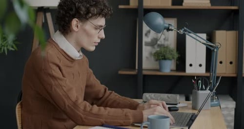 Successful Businessman Working with Laptop Typing Concentrated on Office Work Alone