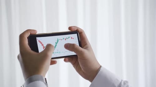 Profitable trader rejoices. The male trader who follows the stock market rejoices.