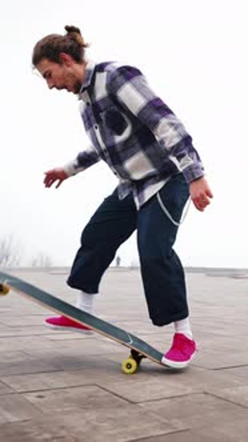 Freestyle Skateboarding Style Jump and Flip of the Skate in the Air Maintain Balance with your Hand