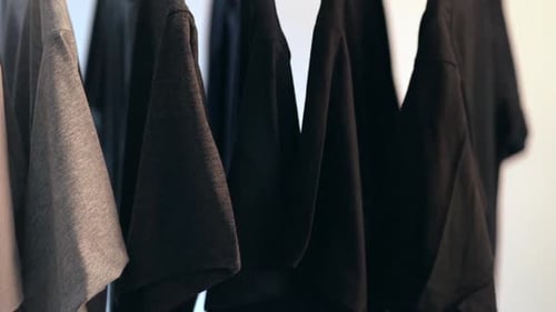 Neutral T-Shirts Hanging on Rack, Fashionable Clothing