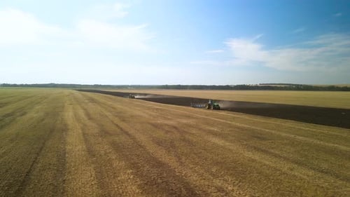 Tractors plowing the field in Ukraine