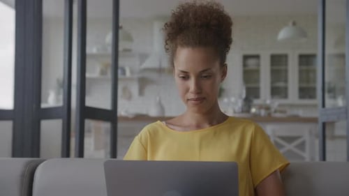 Woman Working on Laptop Computer in Home