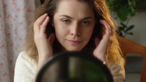 Face Yoga Woman Making Herself Face Lifting Massage Looking in Mirror