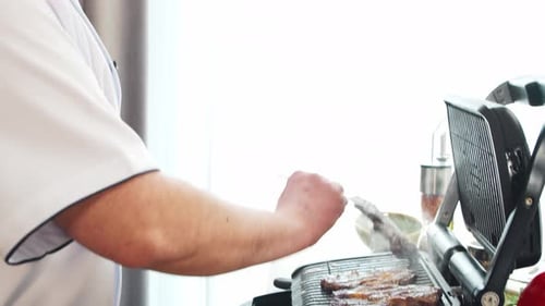 Chef Grills Steak In Kitchen Setting