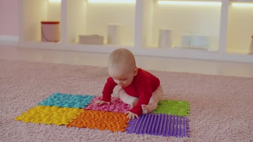 Baby Exploring Colorful Textured Play Mats at Home