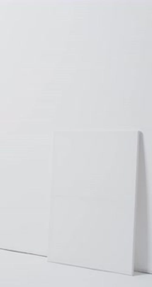 Vertical video of white canvas sign with copy space on floor against white background