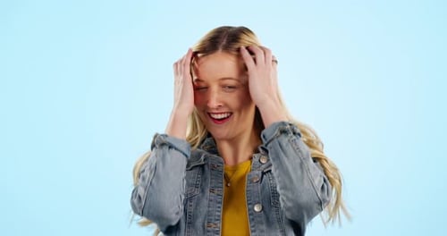 Face, hair care and hands of happy woman in studio isolated on blue background