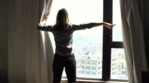 Woman Unveil Curtain And Admire View From Window At Home
