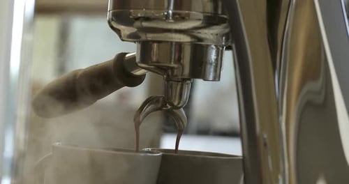 Concept Drinking Roasted Black Coffee in the Morning Pouring Coffee Stream From Machine in Cup