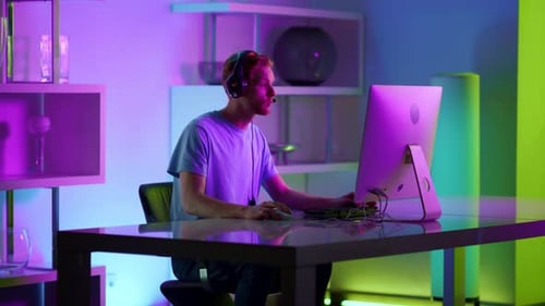 Man Playing Video Game with Headset at Night