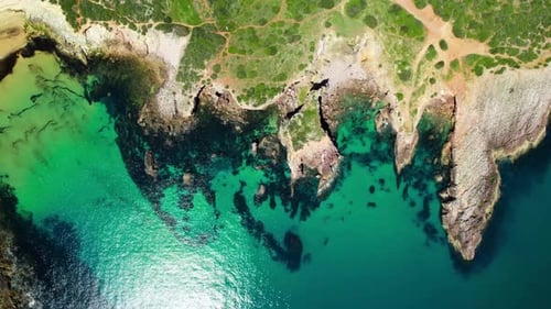 Aerial View of Turquoise Coastline with Rugged Cliffs