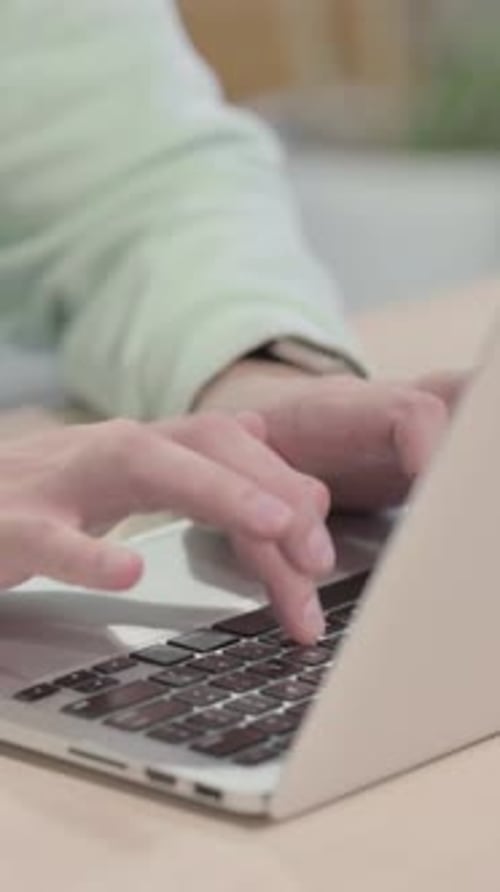 Close up of Young Man Typing on Laptop, vertical video